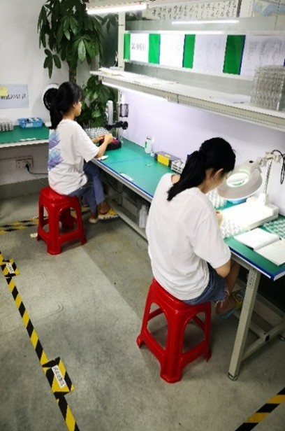 Team members assembling hair dryers